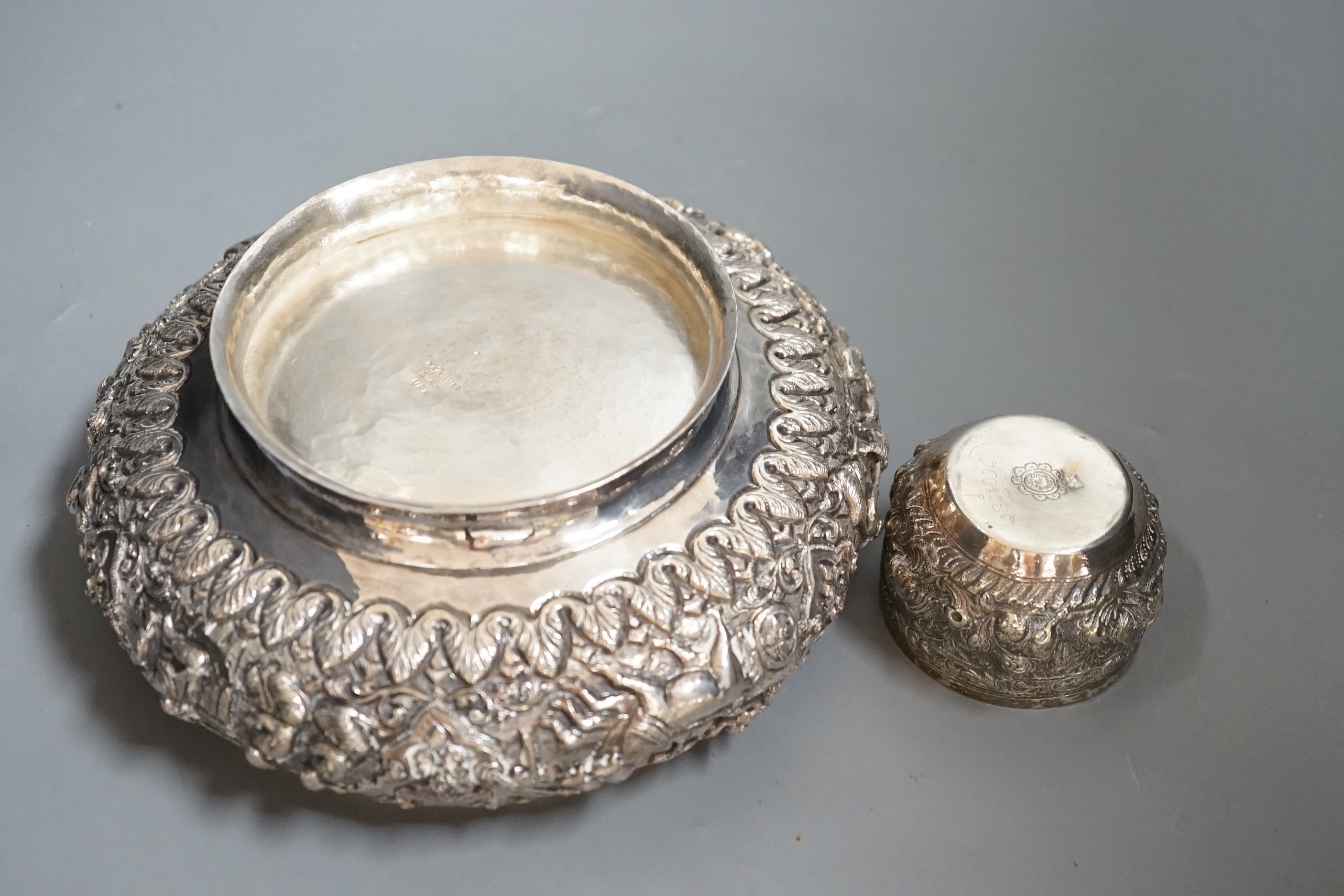 An Indian repousse white metal presentation bowl, with engraved inscription, diameter 21.5cm and a similar smaller bowl